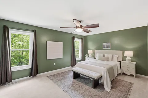 a bedroom with a large bed and a window