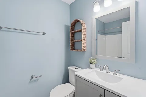 a bathroom with a sink toilet and vanity