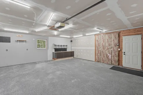 a view of an empty room with closet and cabinet