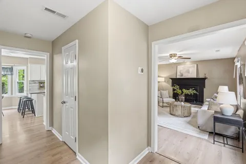 a hallway with a dining table and chairs