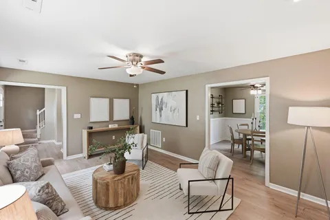 a living room with furniture and a wooden floor