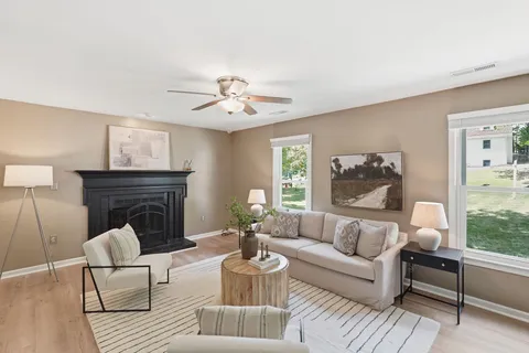 a living room with furniture and a fireplace