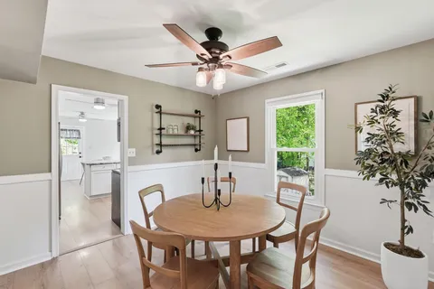 a dining room with furniture and window