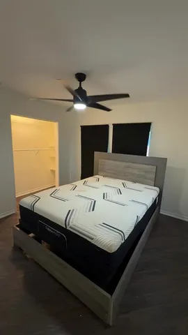 a bed sitting in a bedroom next to a window