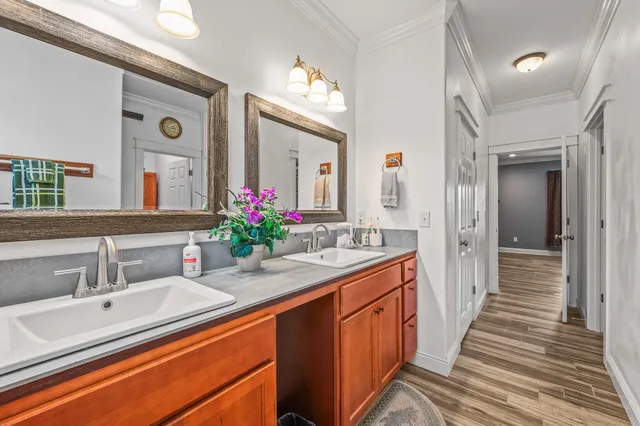 a bathroom with a sink double vanity granite and a large mirror