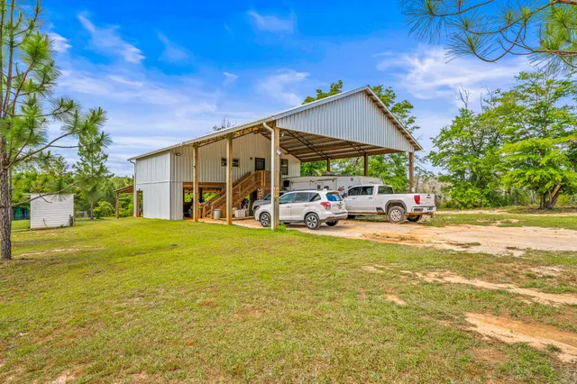 a bedroom with a bed and a large mirror on the dresser