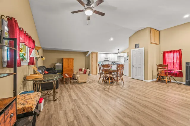 a bedroom with a bed and closet with wooden floor