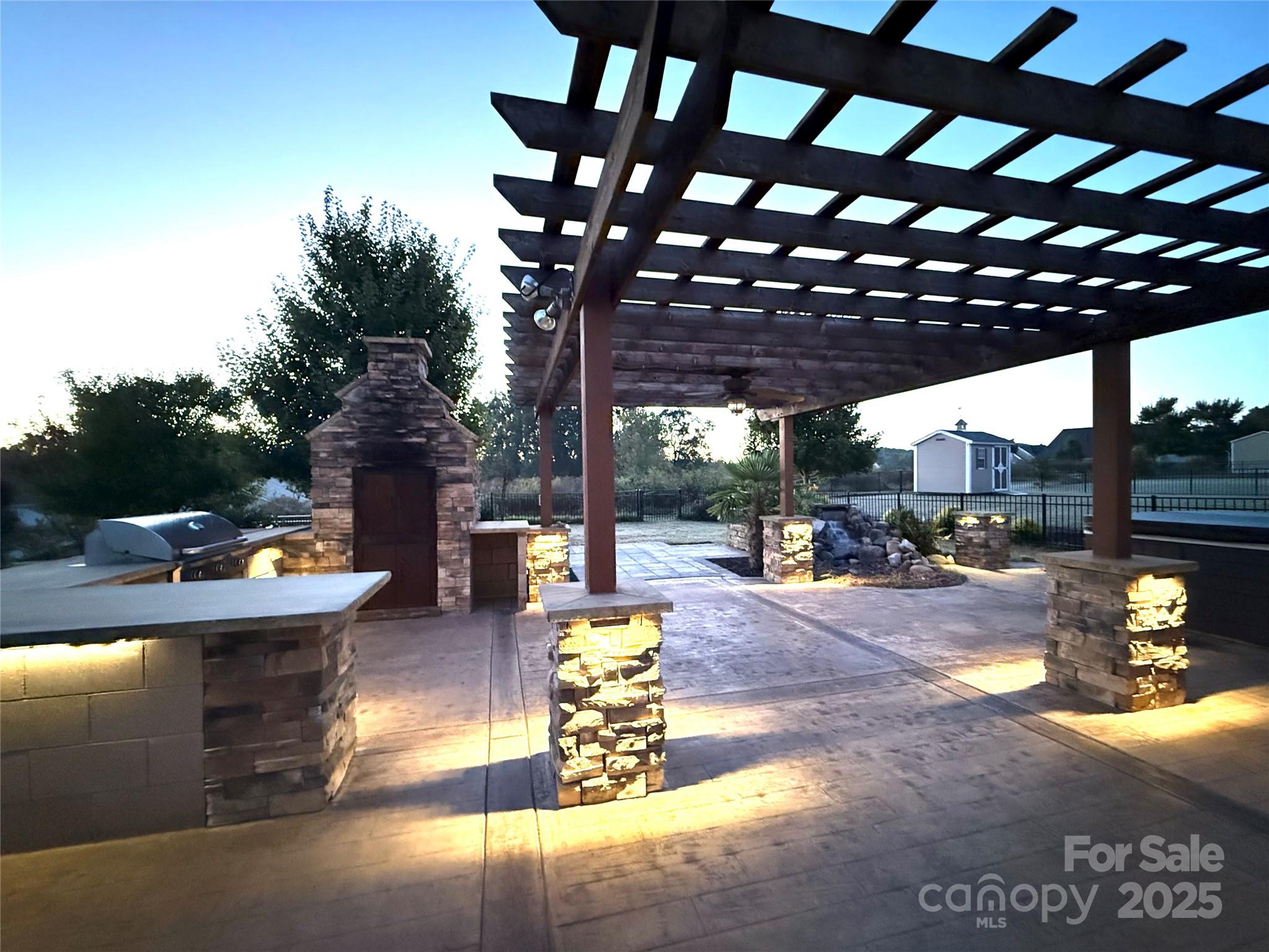 a view of a patio with dining table and chairs with a small yard