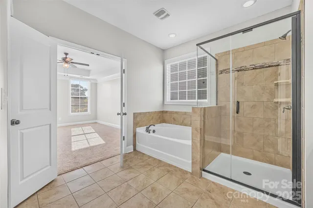 a bathroom with a bathtub and a shower