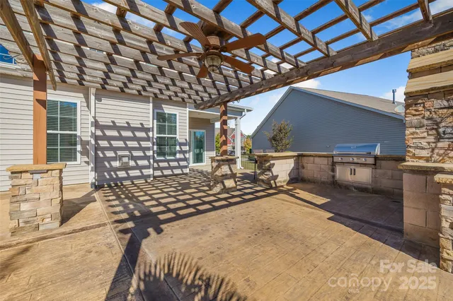 a roof deck with couch and chairs