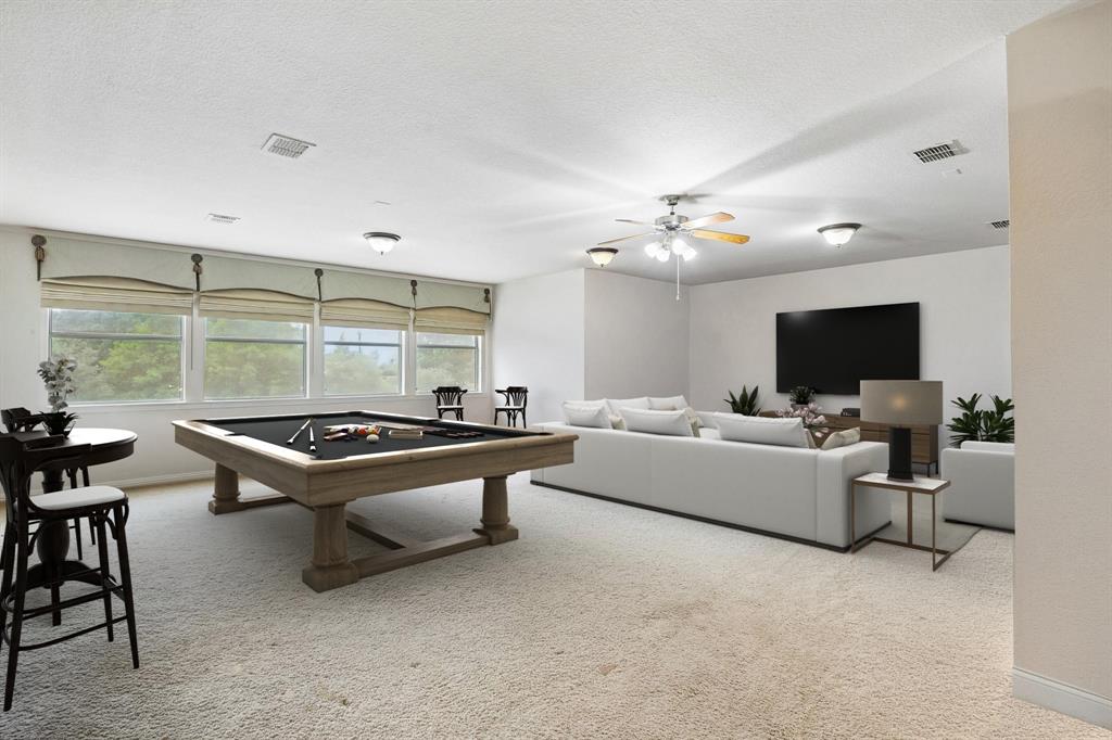 5802 Corinth Chapel Road Parker, TX 75002 - Photo 27 of 40 This huge space found just up the stairs is a perfect game room - media room combination. The room offers carpet, ceiling fan and a wall of windows with views of the backyard. Off of this room find a large walk-in storage closet and a powder room. Virtually staged to show potential.