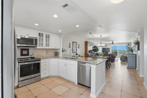 a kitchen with stainless steel appliances kitchen island granite countertop a sink and cabinets
