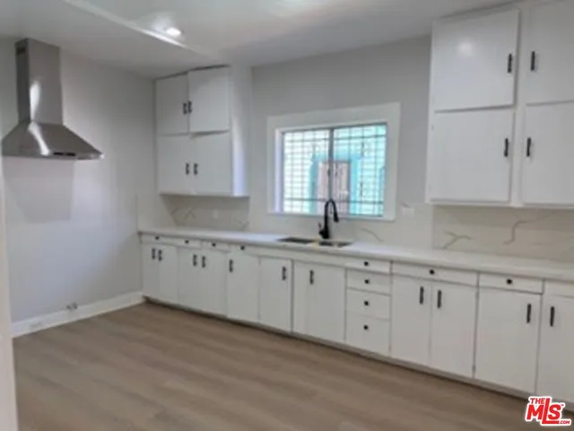 a kitchen with granite countertop white cabinets white appliances with a sink and dishwasher