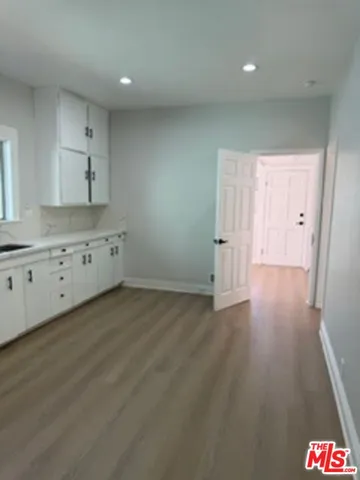 a view of a kitchen with wooden floor