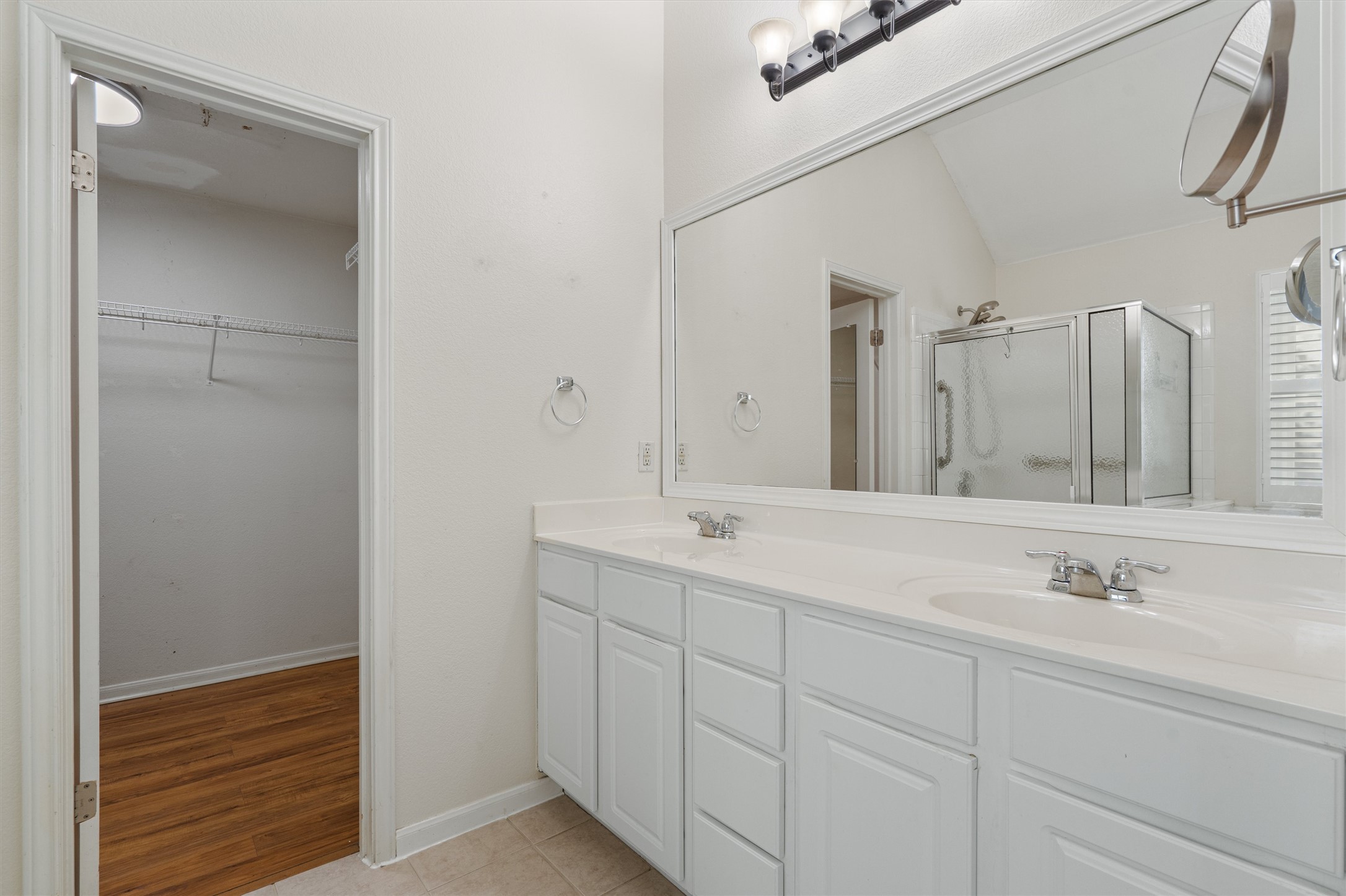 153 Hickory Lane Georgetown, TX 78633 - Photo 16 of 30 Double vanity featuring white cabinetry, integrated sinks, chrome fixtures, and a spacious wall-mounted mirror