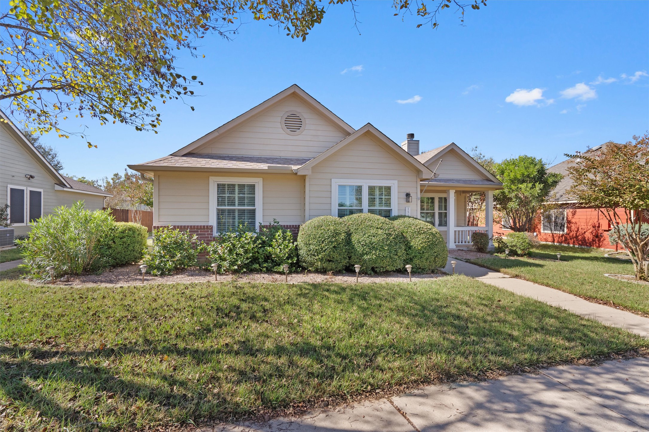 153 Hickory Lane Georgetown, TX 78633 - Photo 2 of 30 Siding exterior with brick detailing, a covered front porch, and mature landscaping