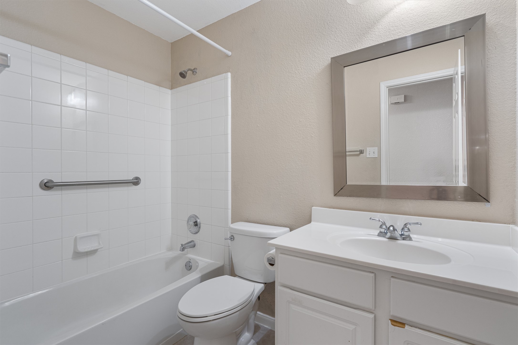 153 Hickory Lane Georgetown, TX 78633 - Photo 24 of 30 Bathroom featuring a white vanity with integrated sink, chrome faucet, and rectangular framed mirror