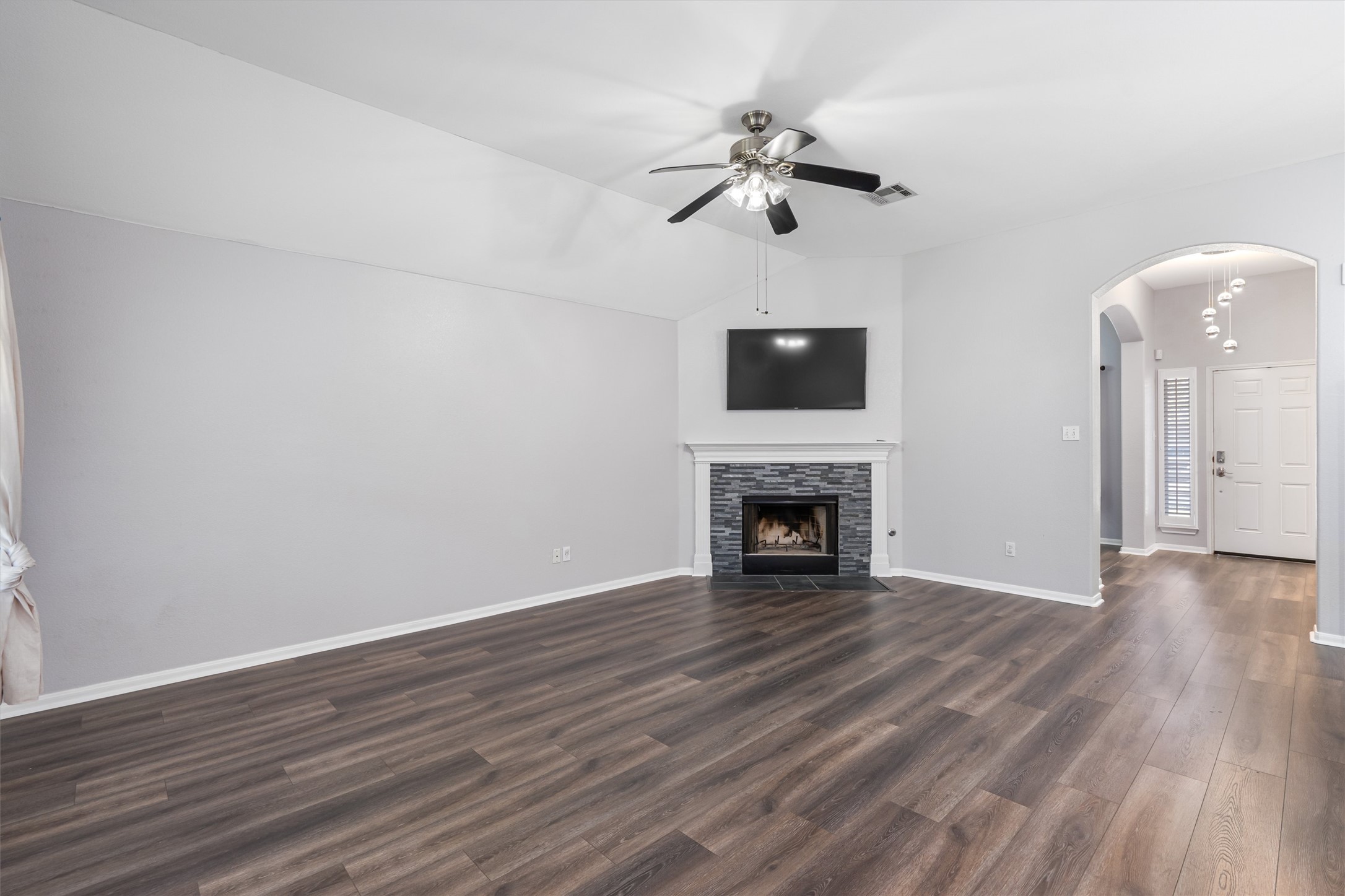 153 Hickory Lane Georgetown, TX 78633 - Photo 5 of 30 Living space featuring wood-finish flooring, a stone-surround fireplace with mantel, and a ceiling fan
