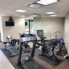 435 South Gulfstream Avenue, Unit 906 Sarasota, FL 34236 - Photo 19 of 22 a room with gym equipment and a flat screen tv