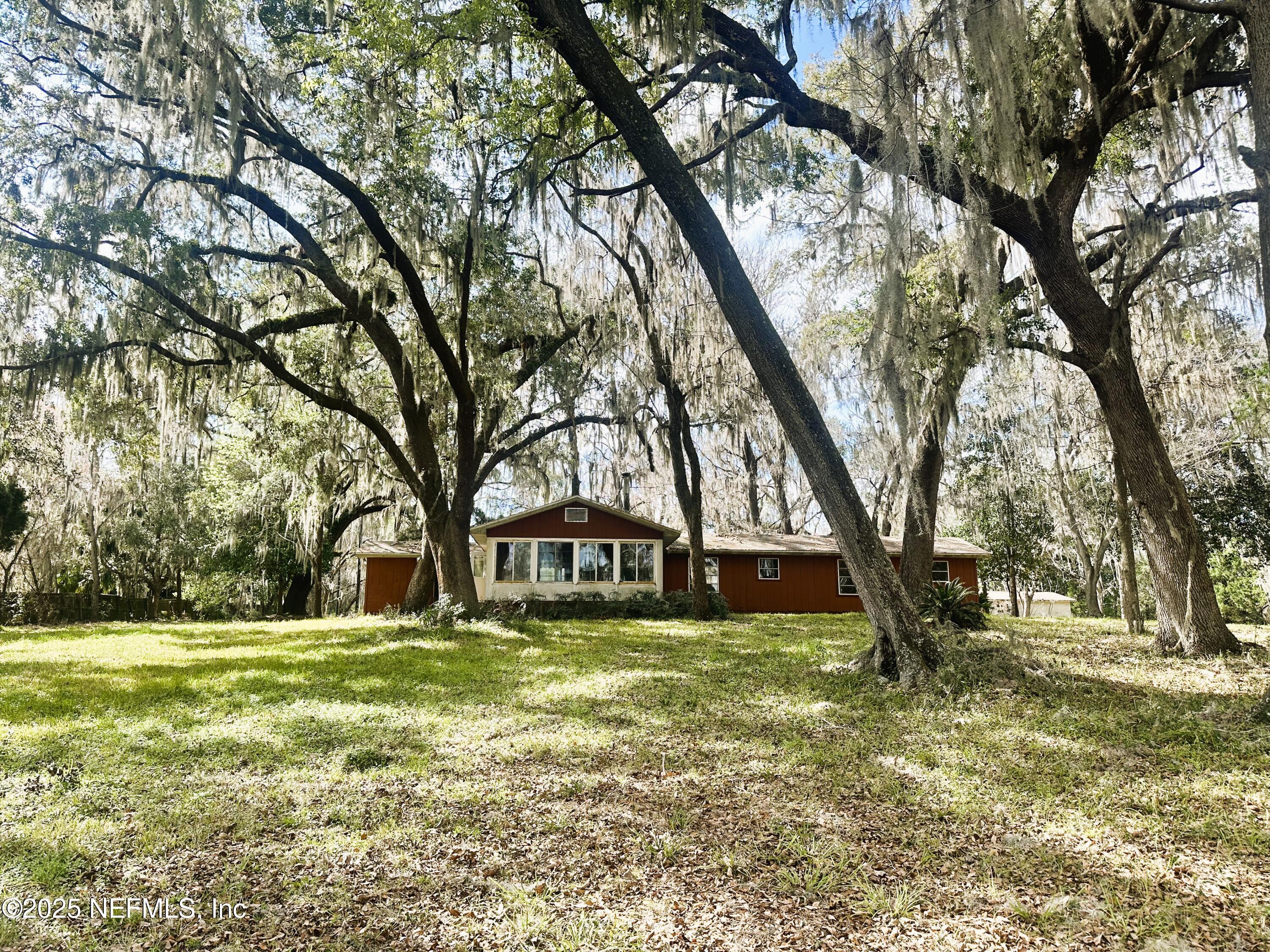 9817 County Road 1469 Earleton, FL 32631 - Photo 22 of 23 a view of swimming pool with trees in the background