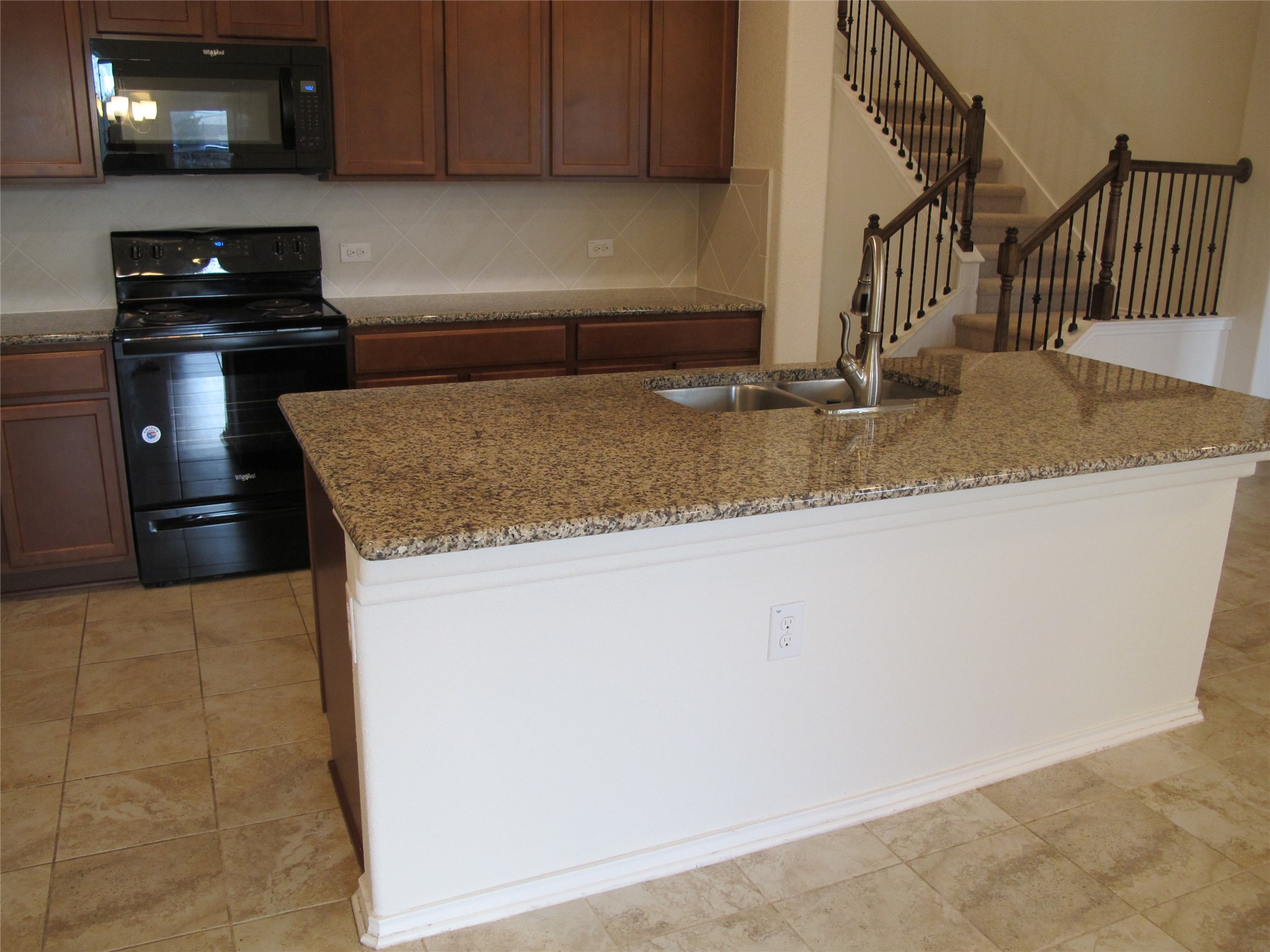 7820 Big Wind Way Austin, TX 78724 - Photo 14 of 37 a kitchen with granite countertop a sink and a stove