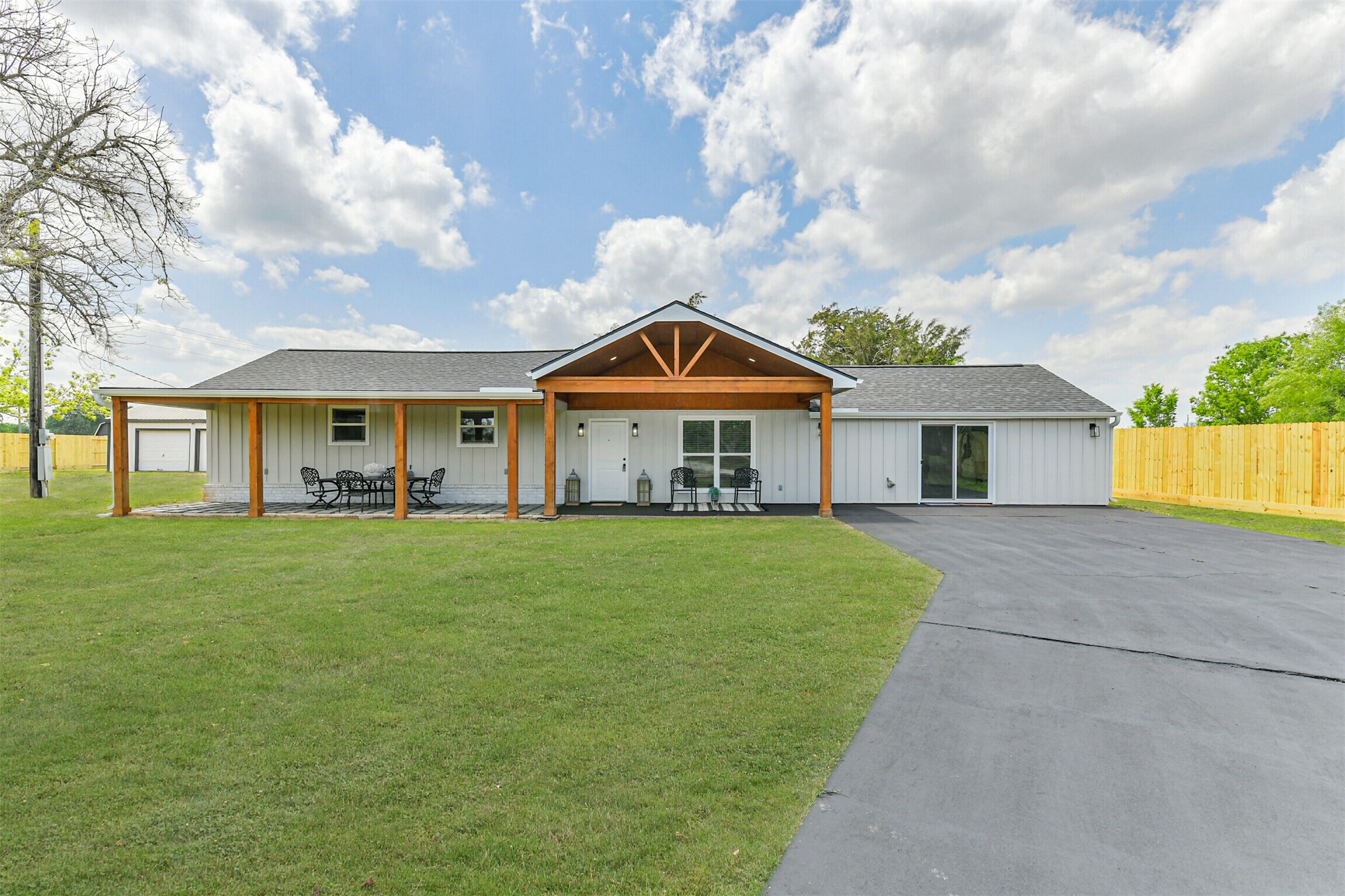a front view of a house with a garden