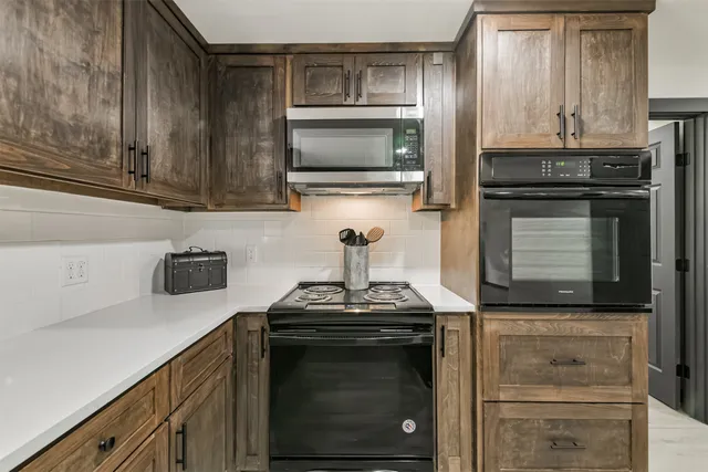 a kitchen with a stove and a microwave