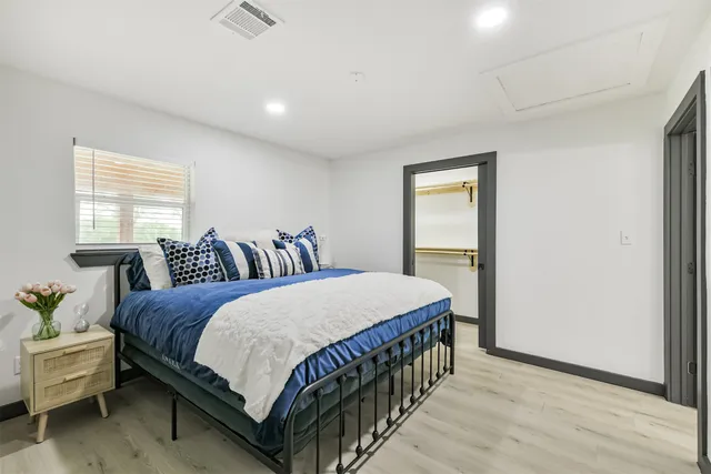 a bedroom with a bed and a table