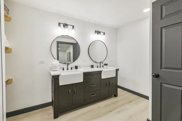 a bathroom with a double vanity sink and a mirror
