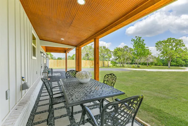 a view of an outdoor dining space with furniture and garden