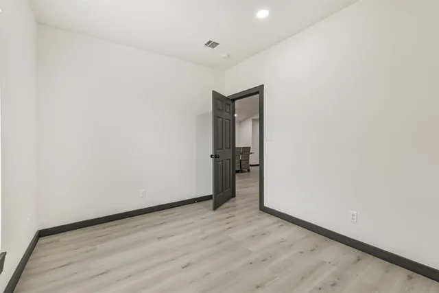 a view of hallway with wooden floor