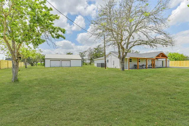 a front view of house with yard and trees