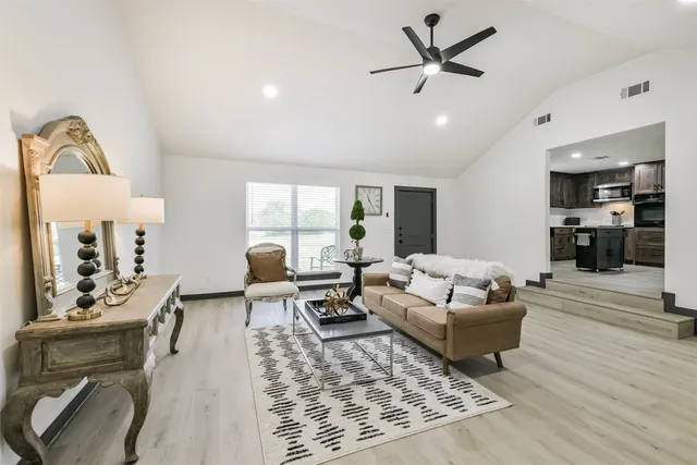 a living room with furniture and wooden floor
