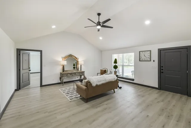 a living room with furniture and a wooden floor