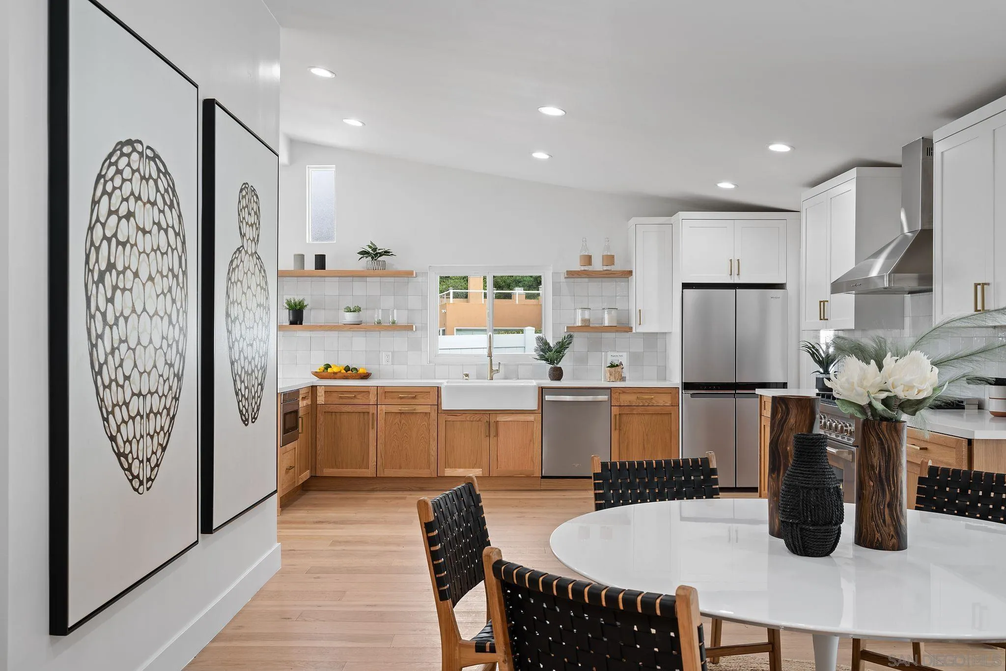 2364 Rue Adriane La Jolla, CA 92037 - Photo 11 of 27 a kitchen with a refrigerator and white cabinets
