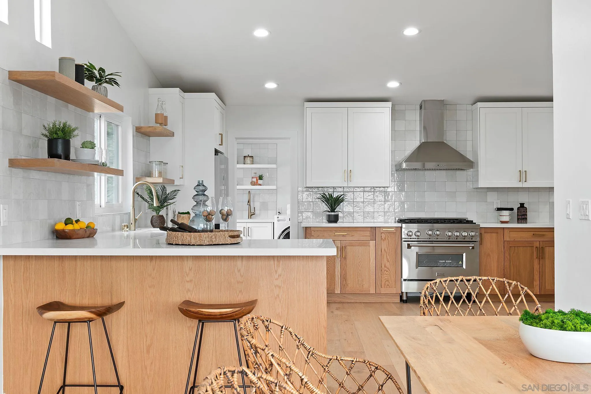 2364 Rue Adriane La Jolla, CA 92037 - Photo 12 of 27 a kitchen with stainless steel appliances granite countertop a white cabinets and stove top oven