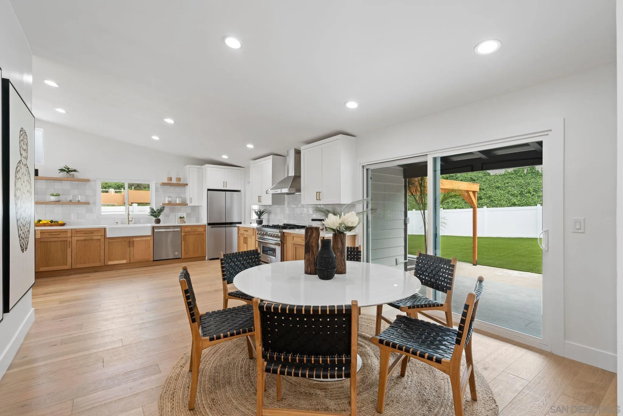 2364 Rue Adriane La Jolla, CA 92037 - Photo 14 of 27 a view of a dining room with furniture a rug and wooden floor