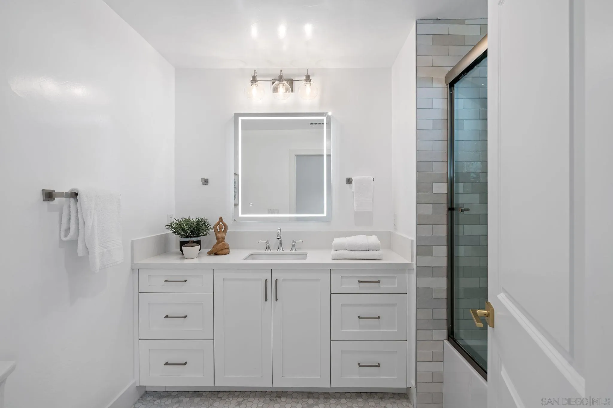 2364 Rue Adriane La Jolla, CA 92037 - Photo 21 of 27 a bathroom with a double vanity sink and mirror