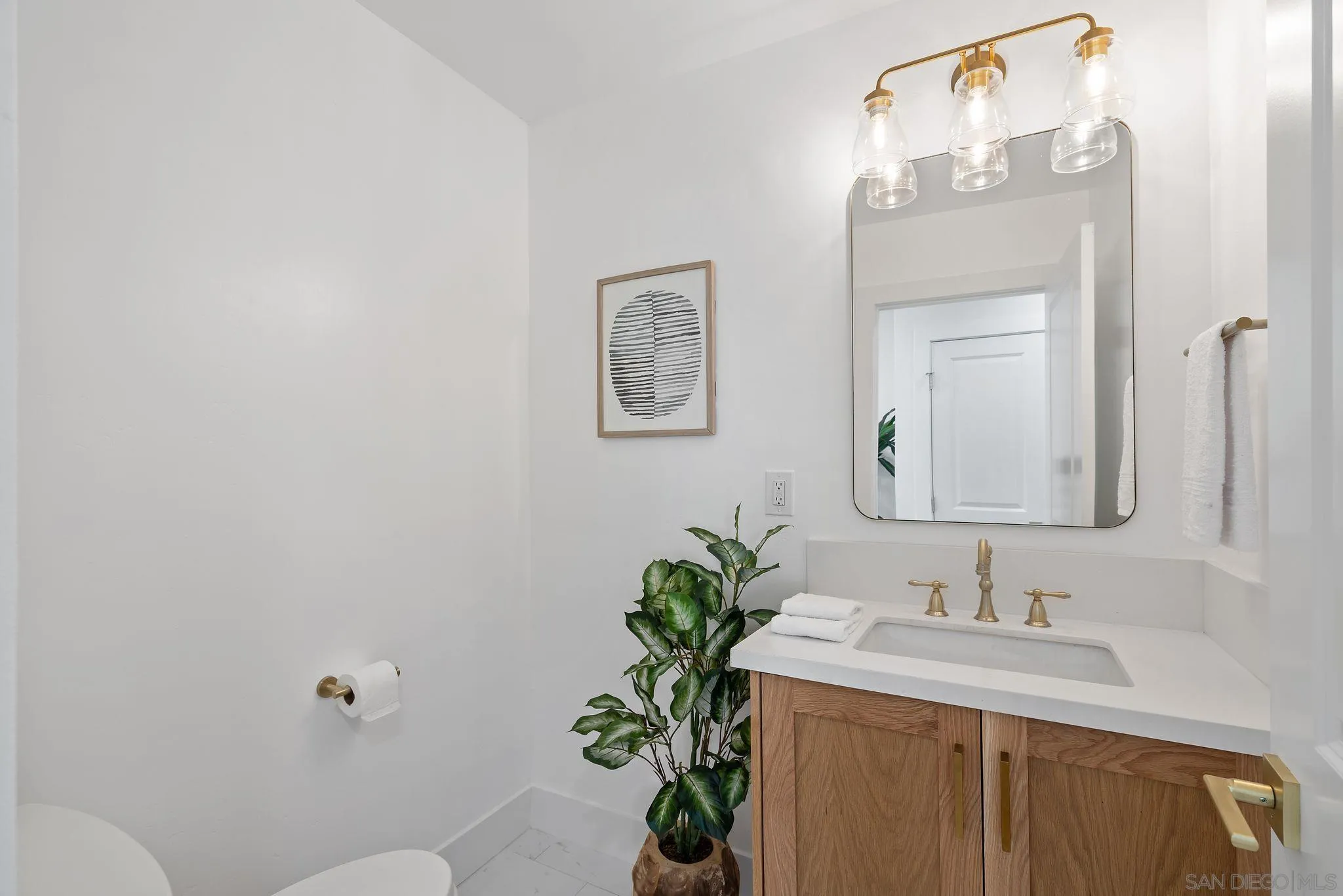 2364 Rue Adriane La Jolla, CA 92037 - Photo 22 of 27 a bathroom with a granite countertop sink a toilet and a mirror