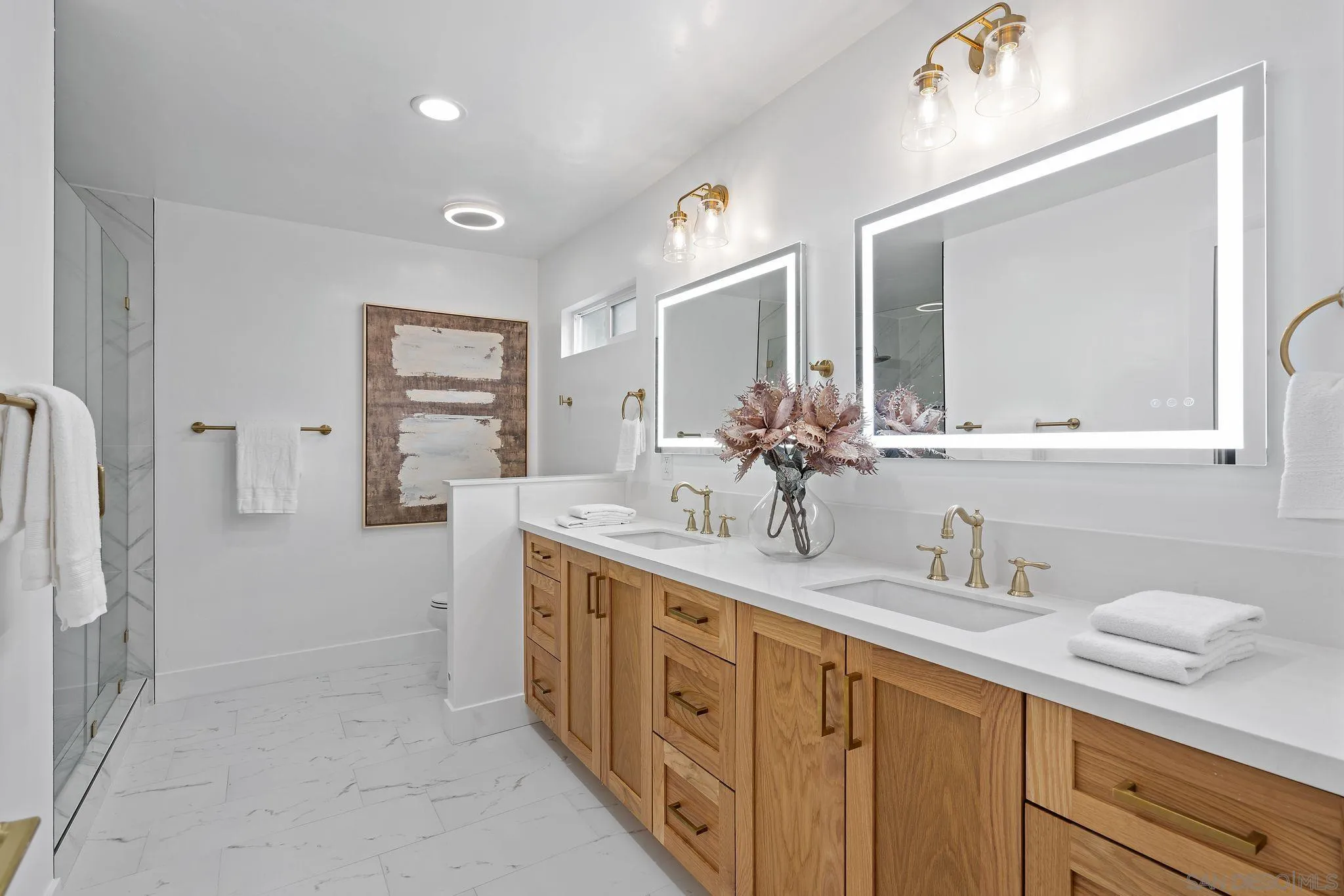 2364 Rue Adriane La Jolla, CA 92037 - Photo 23 of 27 a spacious bathroom with double sink and a mirror