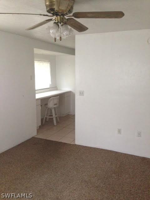 8061 Country Road, Unit 201 Fort Myers, FL 33919 - Photo 2 of 10 a workspace with chandelier fan