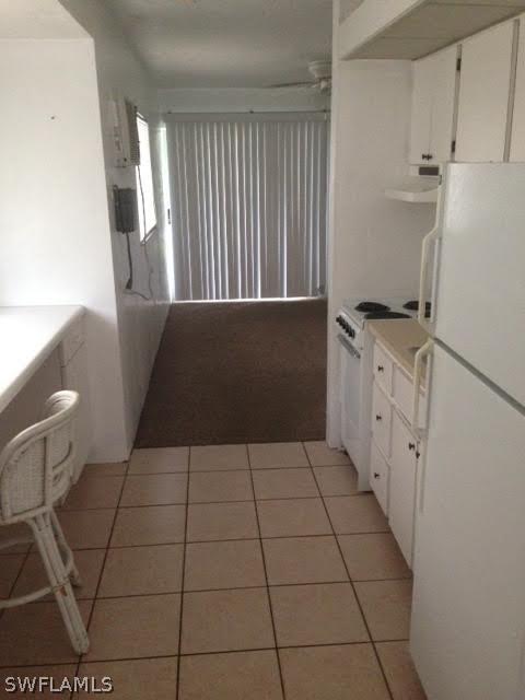 8061 Country Road, Unit 201 Fort Myers, FL 33919 - Photo 3 of 10 a kitchen with a sink a toilet and a mirror
