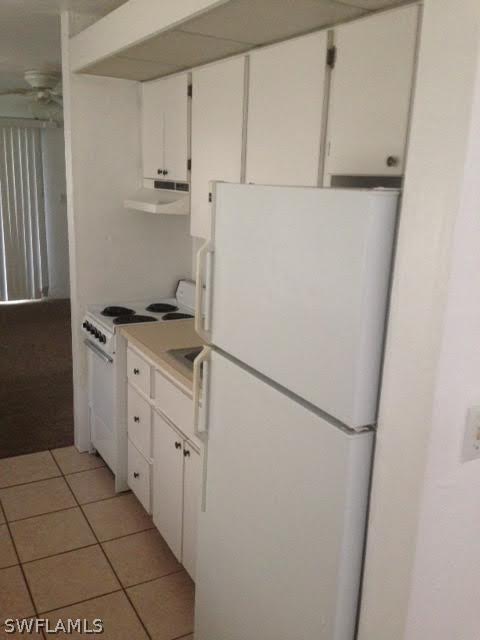 8061 Country Road, Unit 201 Fort Myers, FL 33919 - Photo 4 of 10 a kitchen with cabinets a refrigerator and a stove