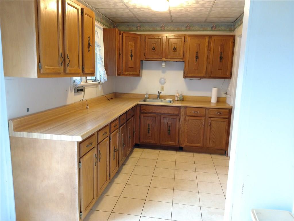 471 Park Street Rochester, PA 15074 - Photo 4 of 10 a kitchen with a sink a cabinets and window