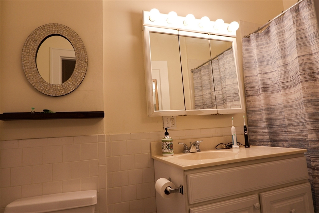 1253 Beacon Street, Unit A5 Brookline, MA 02446 - Photo 5 of 5 a bathroom with a sink and a mirror
