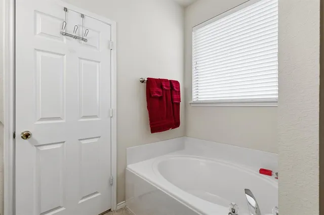 a bathroom with a bathtub and shower