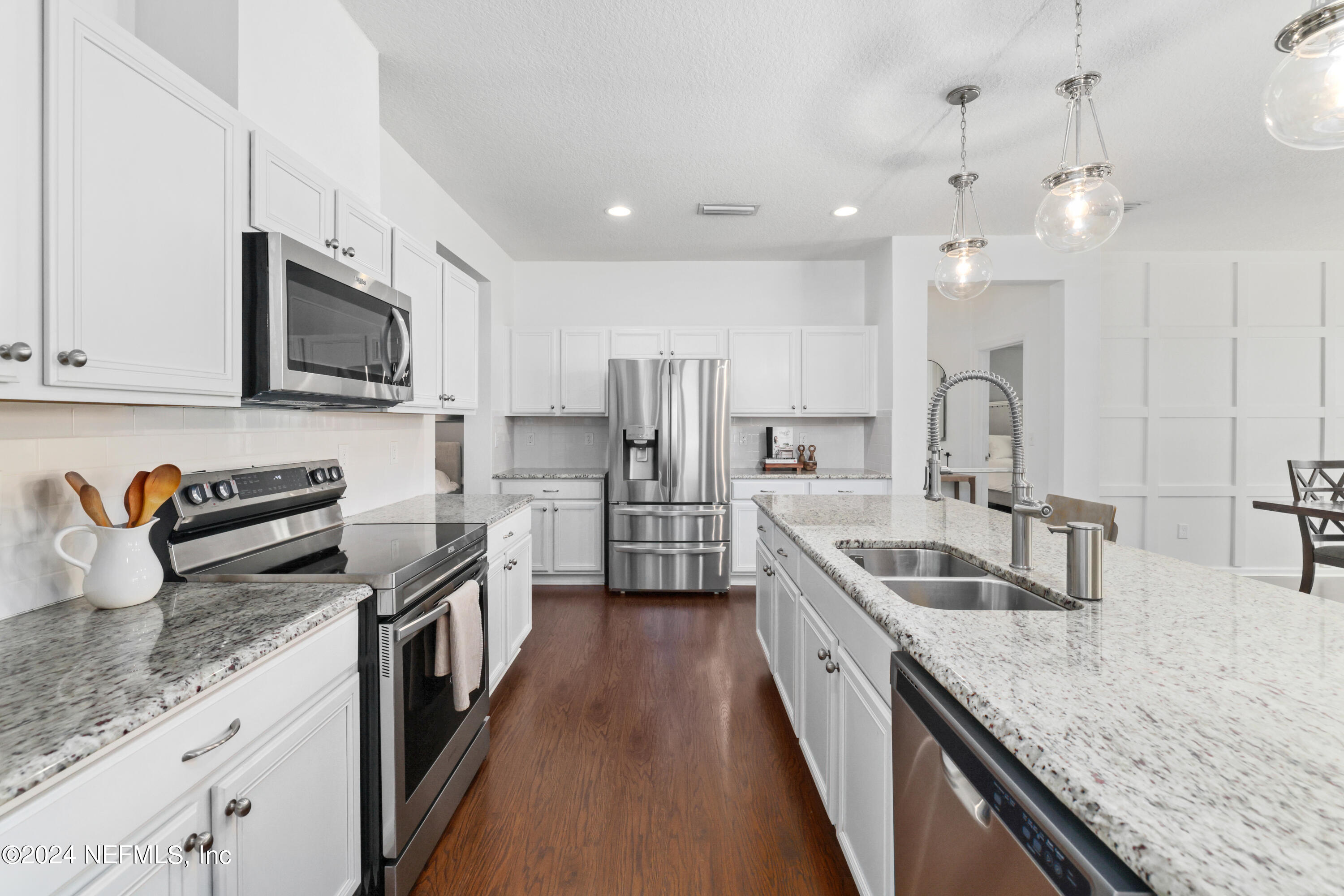 192 Peter Island Drive St. Augustine, FL 32092 - Photo 13 of 43 a kitchen with stainless steel appliances granite countertop a sink stove and refrigerator