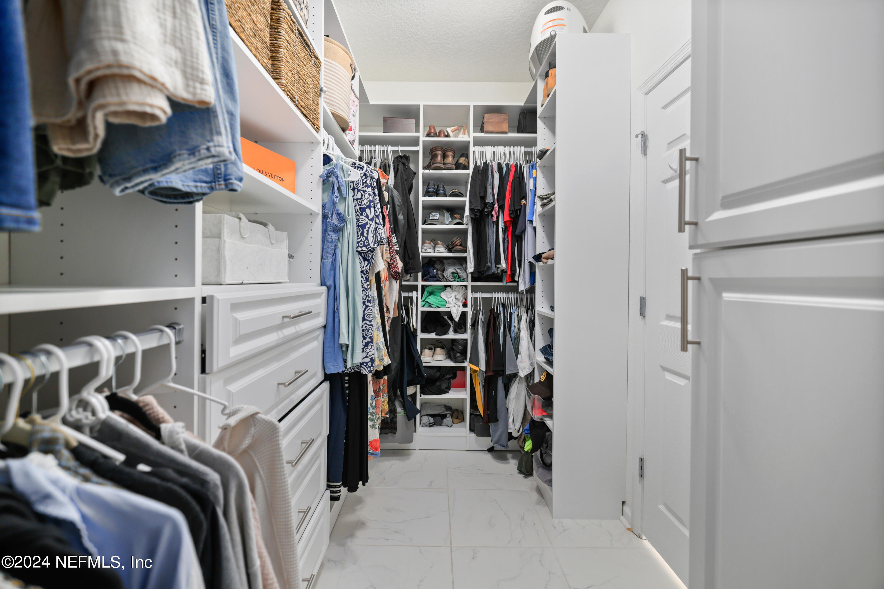 192 Peter Island Drive St. Augustine, FL 32092 - Photo 21 of 43 a view of walk in closet with clothes and shoes