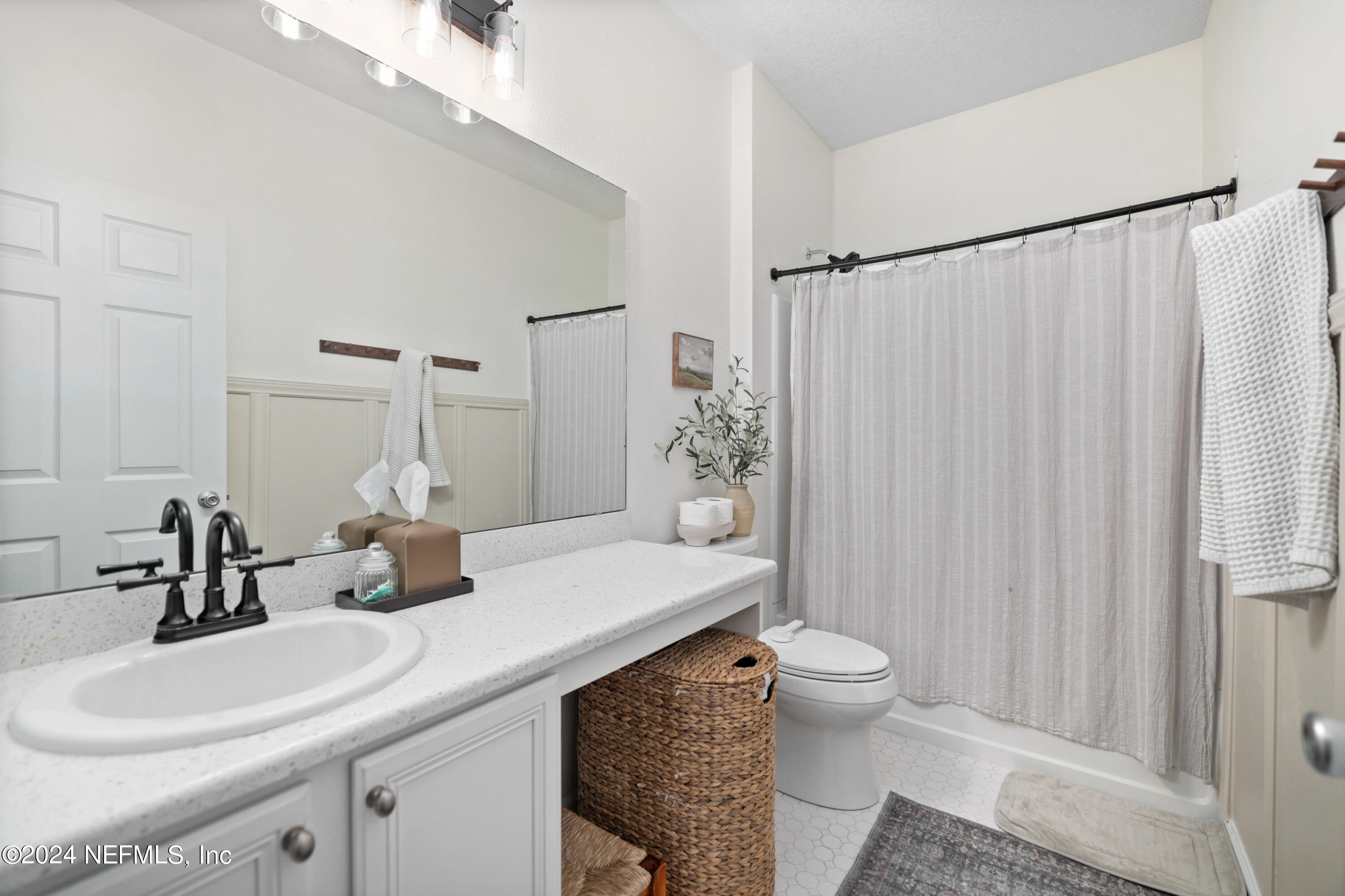 192 Peter Island Drive St. Augustine, FL 32092 - Photo 26 of 43 a bathroom with a sink a toilet and shower curtain