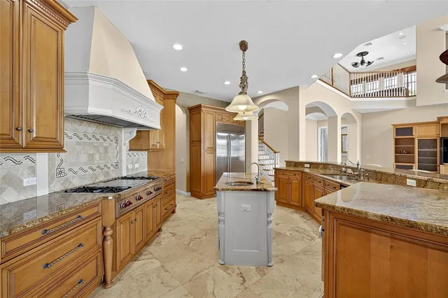 a living room with a couch and a chandelier